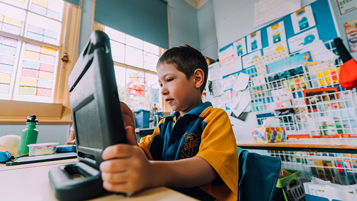 Student using a laptop in the classroom.