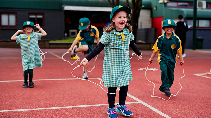 Student using a skipping rope in the playground.