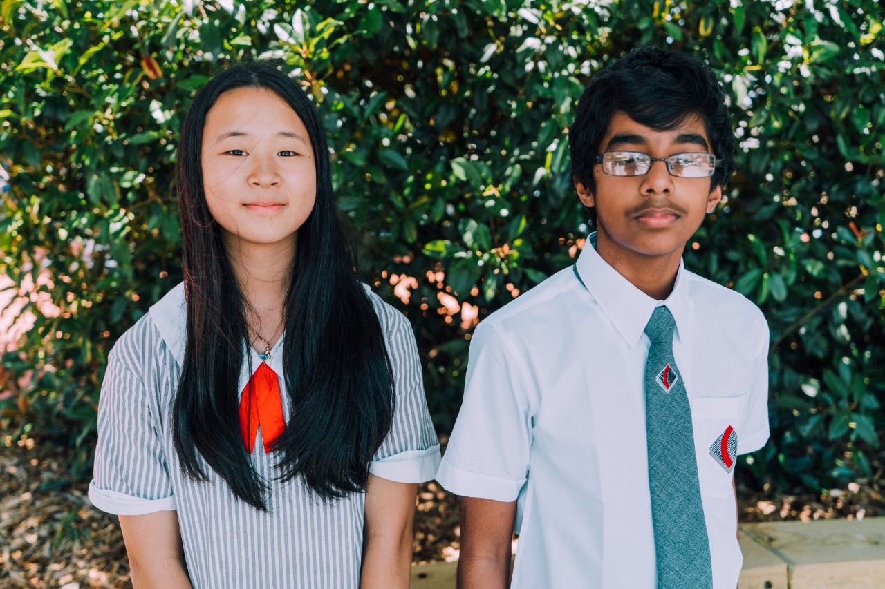 Students posing for a photo in school grounds.