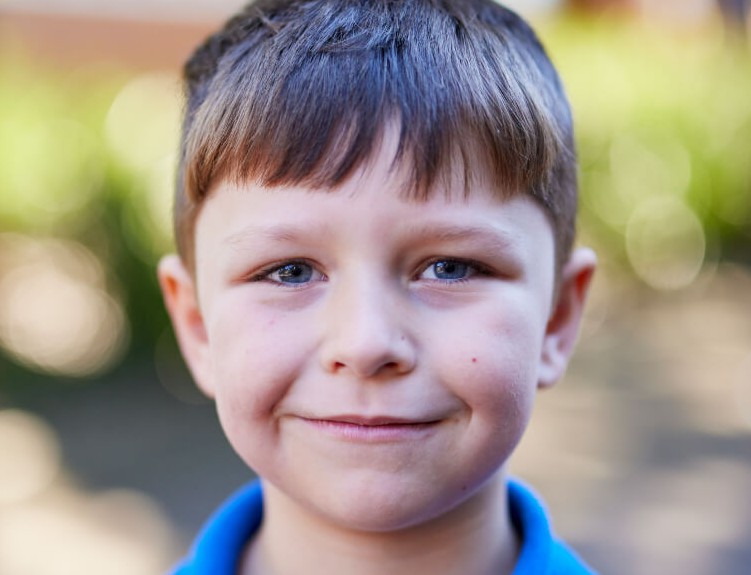 Smiling student standing outdoors. 